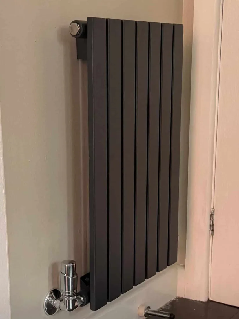 Modern flat panel radiator installed in a renovated space